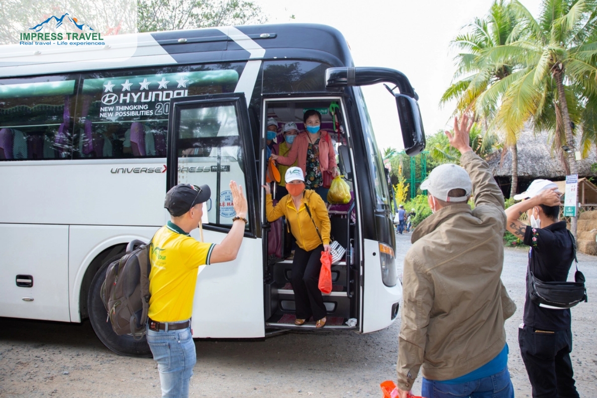 The tour guide welcomed the group at the bus